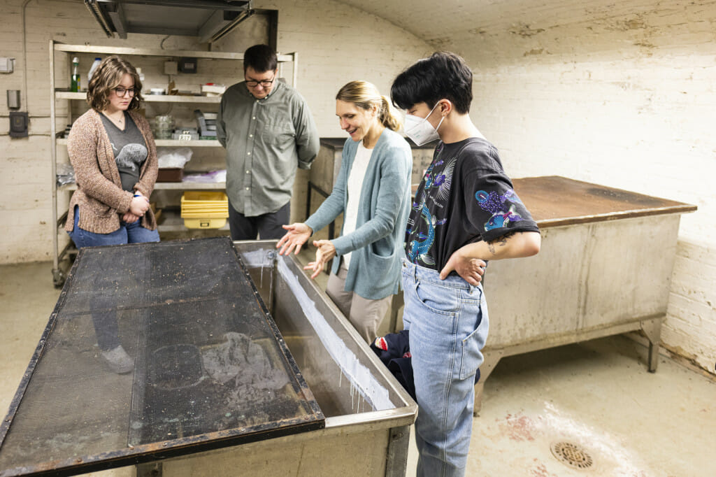 Monahan explains how a colony of dermestid beetles cleans animal skeletal specimens inside of large stainless steel tanks in the Dermesterium, a facility run by the UW Zoological Museum. Also pictured are Mahon; Chris Barncard (center left), University Communications science writer; and Imbler (right).