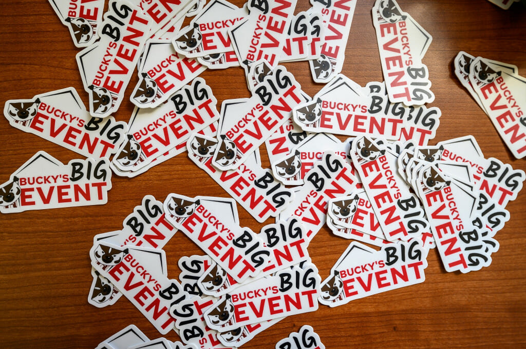Stickers await laptops and water bottles during t-shirt pick-up for Bucky’s Big Event (a service day where students, staff, and faculty can volunteer and engage with the community) at the Memorial Union.