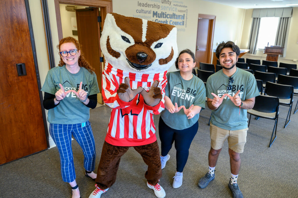 From left to right, Maryellen Pawley, executive assistant for the chancellor; Bucky Badger; Shelby Fosco, co-curricular program manager at the Morgridge Center for Public Service; and Akshay Kalra, undergraduate student, pose together during t-shirt pick-up for Bucky’s Big Event.