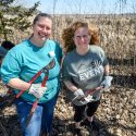 At left, Bryn Scriver, volunteer and outreach coordinator at the Lakeshore Nature Preserve, and Chancellor Mnookin use loppers to remove invasive buckthorn.