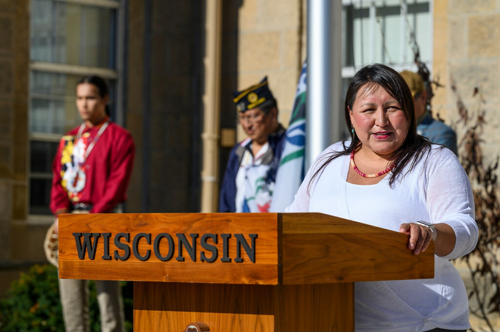 Carla Vigue, tribal relations director in the Office of University Relations, speaks before the Ho-Chunk Nation’s flag is raised on a sunny day at Bascom Hall.