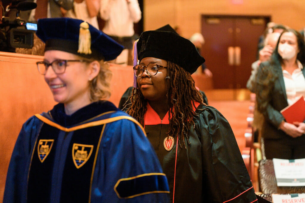 A student enters the music hall as part of the ceremony.