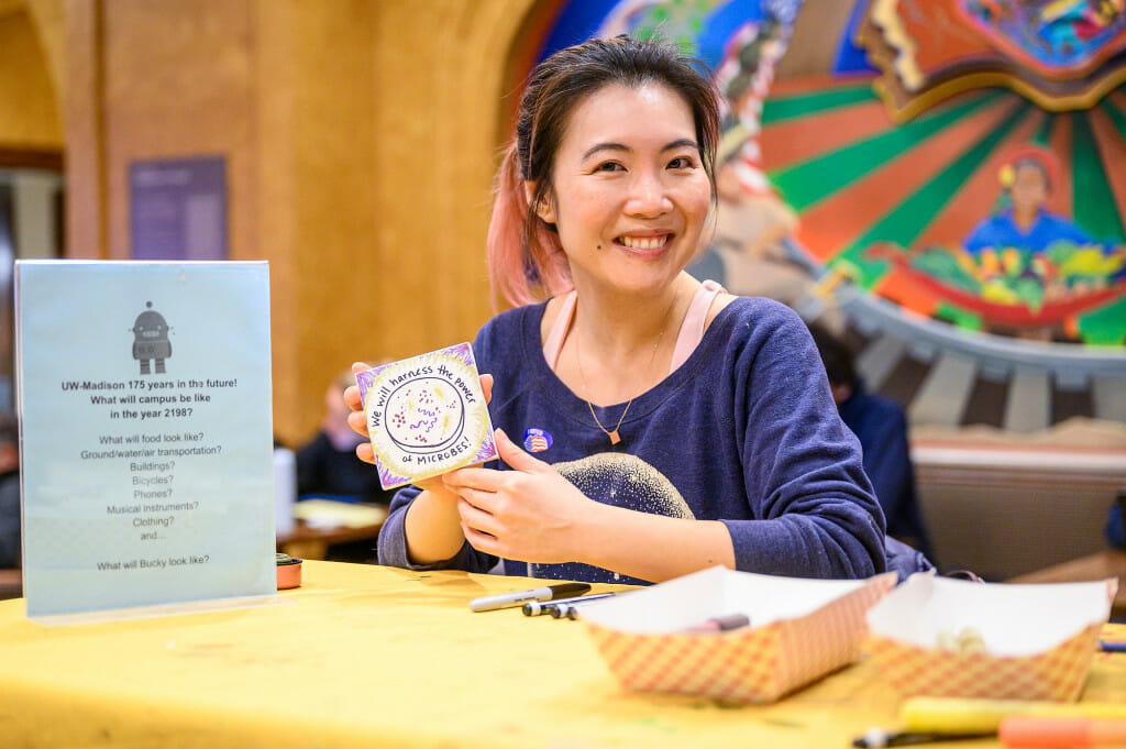 Sharron Tang, a graduate student in molecular biology shows the canvas she made in response to the creative prompt “Imagine UW–Madison in the Year 2198.”