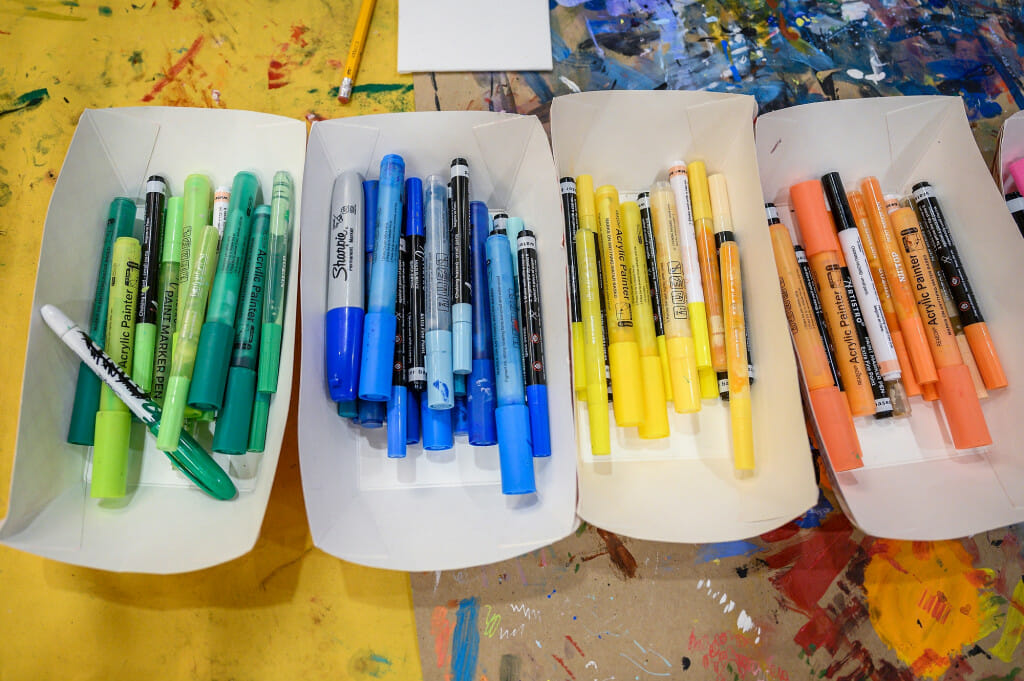 Pens and markers in a rainbow of colors await the creative hands of artists.