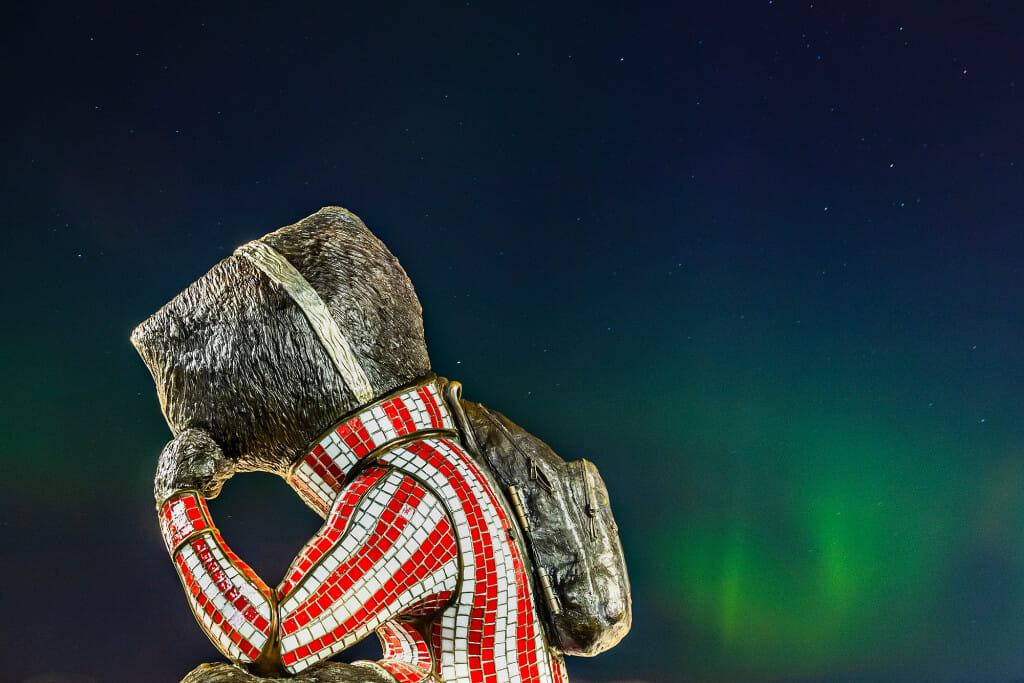 A statue of Bucky Badger seems to gaze at the Northern Lights.