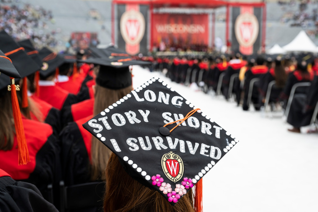 A mortarboard cap reads 