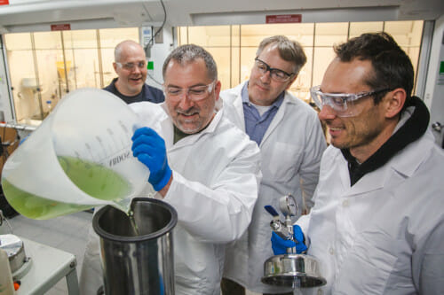 Troy Runge,Professor in the Biological Systems Engineering in CALS, and his research team; Steve Karlen, Jason Coplien, and Jordi Francis Clar, fill a pressure reactor with solution in the lab.