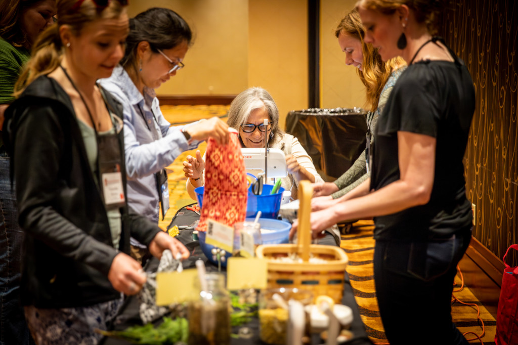 A group of women work at a table.