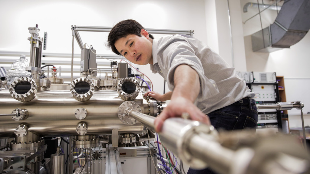 Associate Professor Jason Kawasaki works with a piece of heavy machinery in a lab setting.