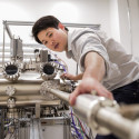 Associate Professor Jason Kawasaki works with a piece of heavy machinery in a lab setting.
