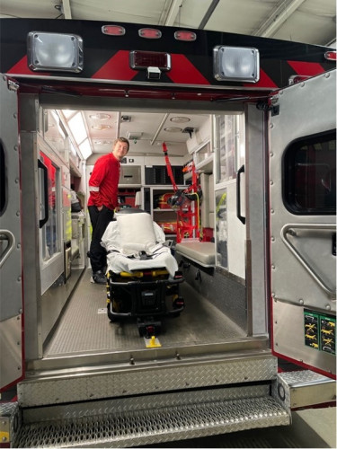 A man walks through an ambulance.