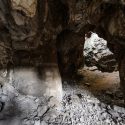 An entrance to the Dinaledi Chamber of the Rising Star Cave system. Light from above shines in at the cave entrance.