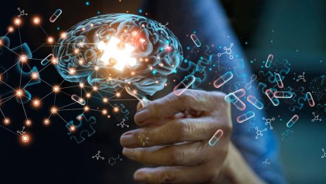 Photoillustration shows the hand of an elderly woman holding a glowing holograph of a brain