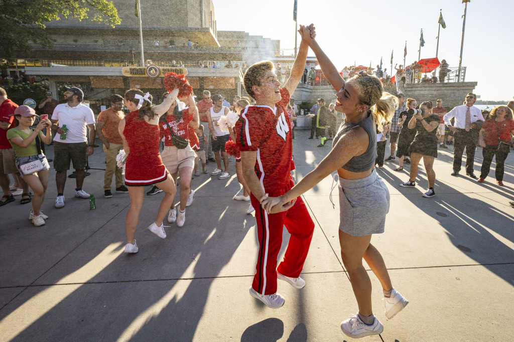 Members of the Spirit Squad dance the polka with people from the crowd.