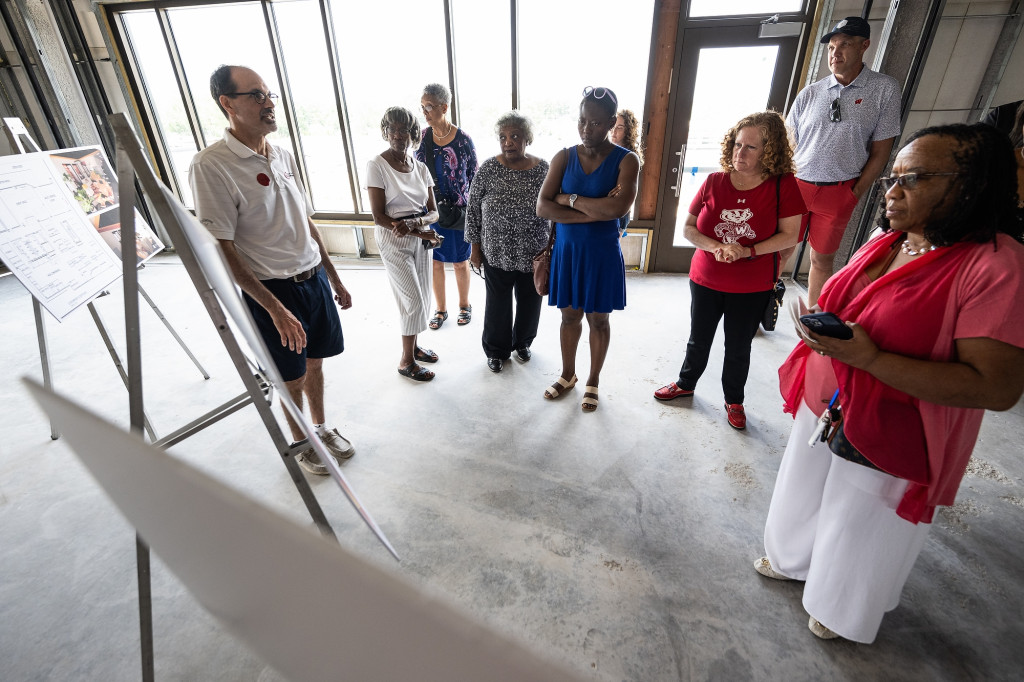 Standing second and third from right, UW–Madison Athletic Director Chris “Mac” McIntosh and UW–Madison Chancellor Jennifer Mnookin listen to Ed Lee (far left), senior vice president of the Urban League of Greater Madison, during a tour of the Hub.