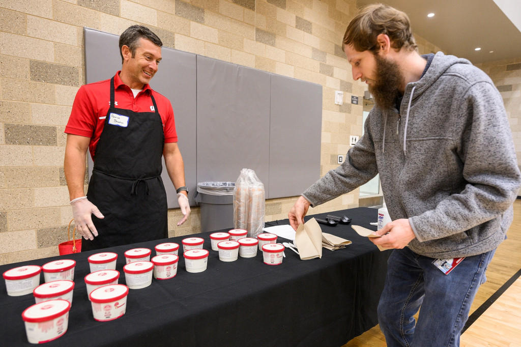 Chief Human Resources Officer Patrick Sheehan offers ice cream to guests.