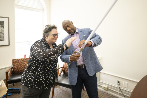 Charles Isbell shows a lightsaber replica on display in his office as he meets with Amy Gilman.