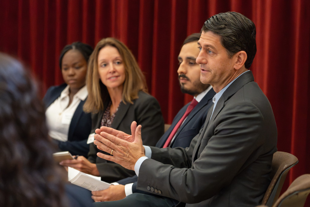 Ryan makes a point; to his right is Carlos Puga, La Follette School Student Association president.