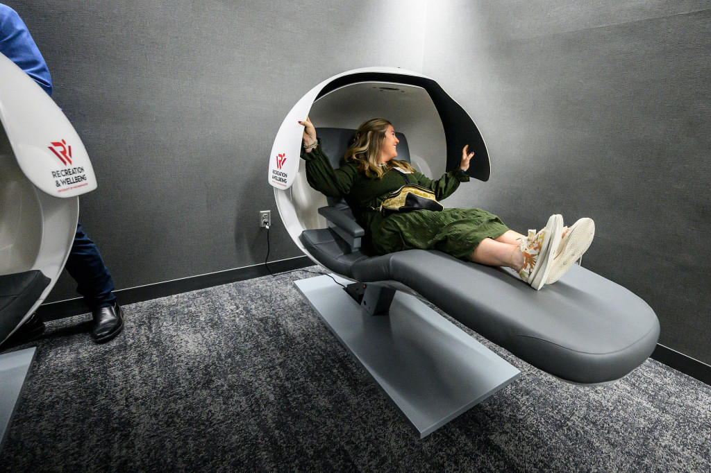 A person lays back in a pod.