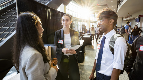 Thee people stop and talk.