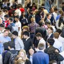 A crowd of young people fill a lobby.