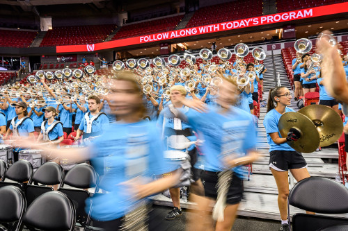 The Marching Band, wearing in bright blue T-shirts, plays for the crowd.