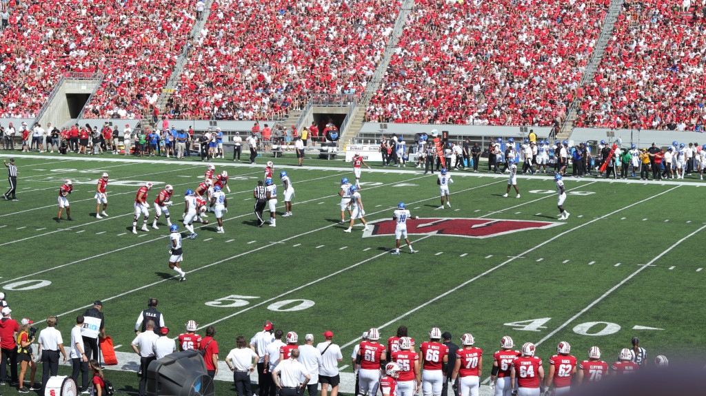 A long view of a football field with fans in the stands.