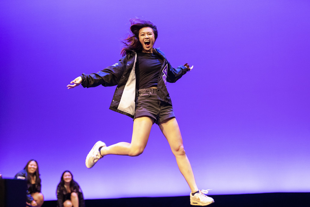 A member of alpha Kappa Delta Phi, Asian-interest sorority, jumps during a performance.