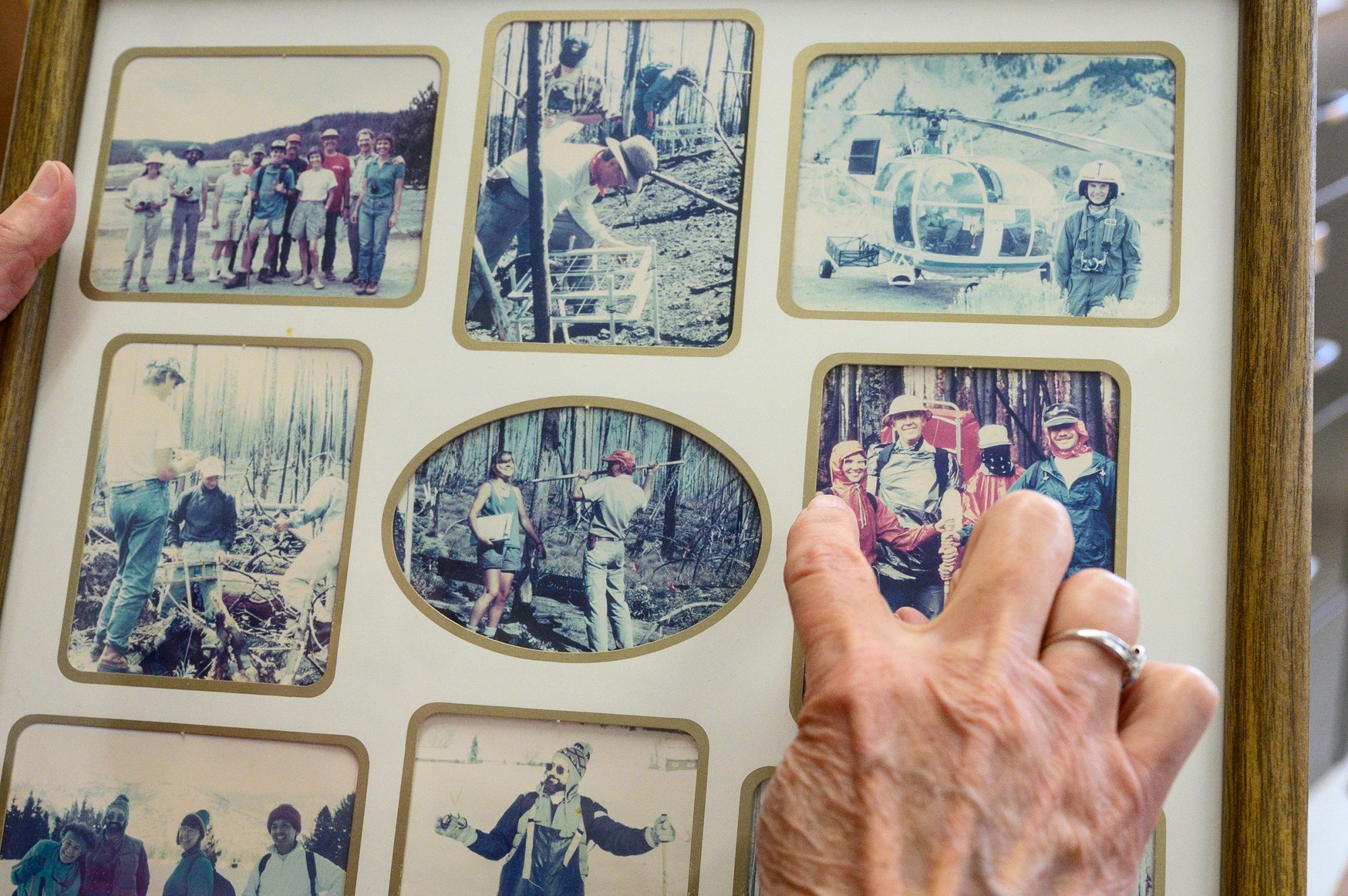 Monica Turner points to people in a faded photo collage.
