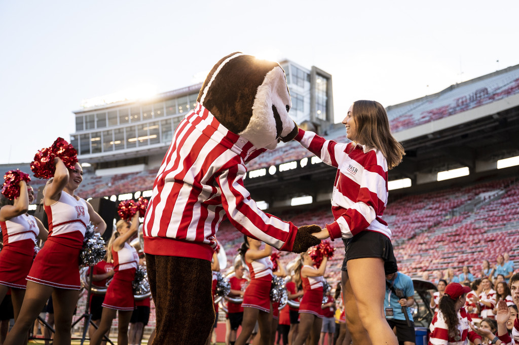 Bucky Badger dances the polka with a student.