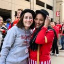 Two law students pose outside of Camp Randall Stadium.