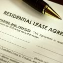 Close-up photo of the header of a lease application. A pen lies across the piece of paper.