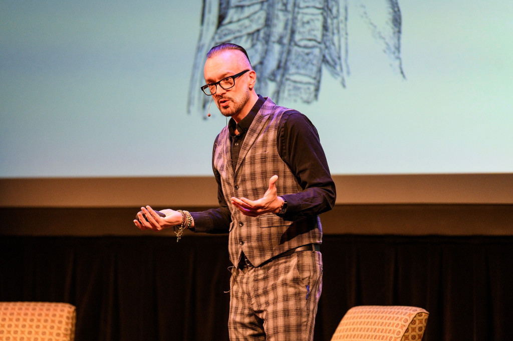 A man stands on the stage and speaks.