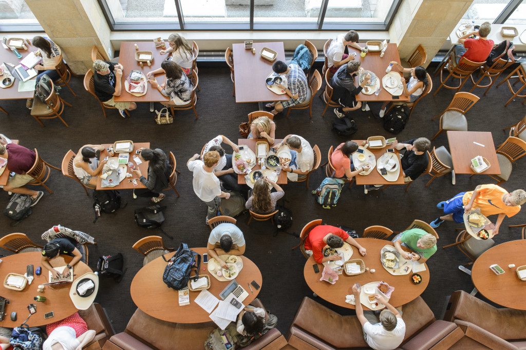 An overhead view of students eating in a dining hall