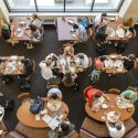 An overhead view of students eating in a dining hall