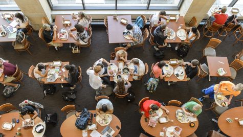 An overhead view of students eating in a dining hall