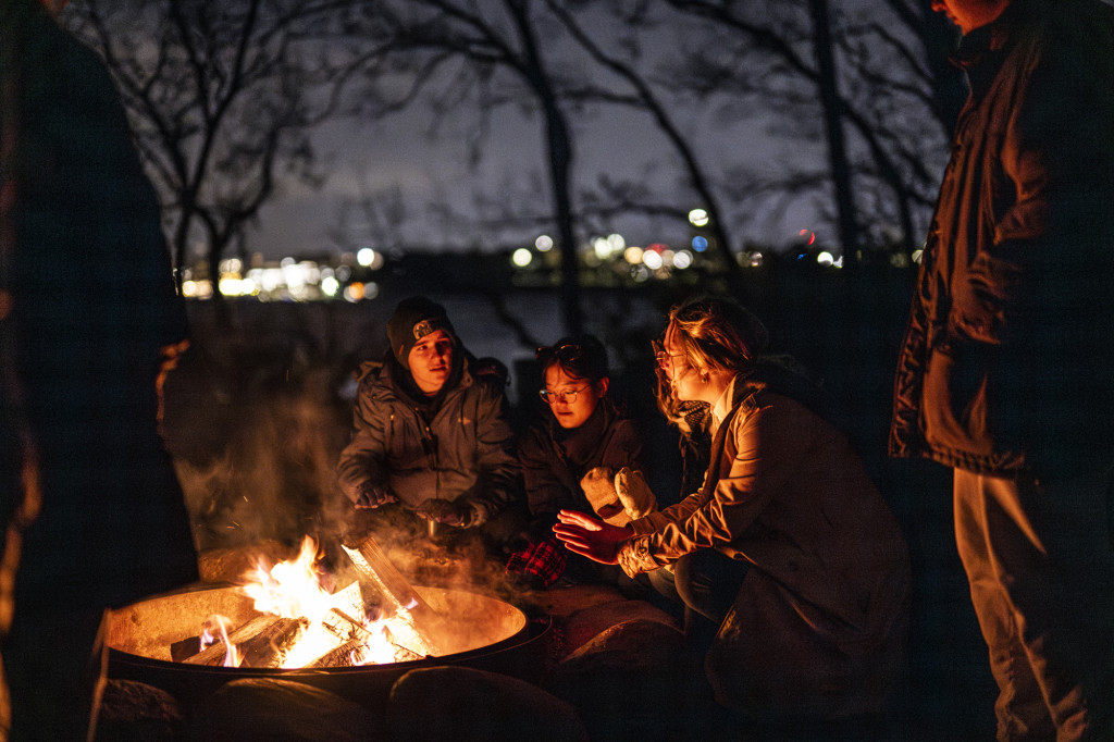 People gather around a campfire.