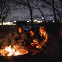 People gather around a campfire.