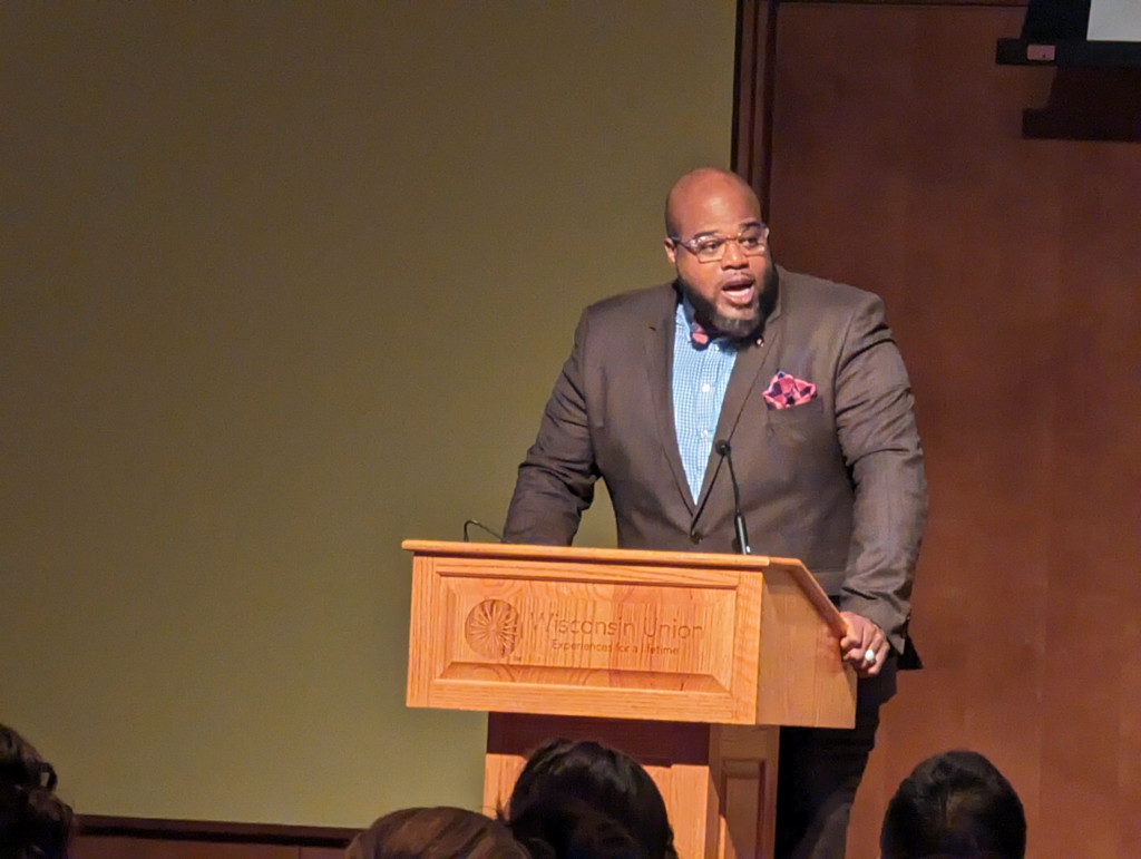 A man speaks at a podium.