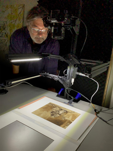 A man examines old manuscripts.