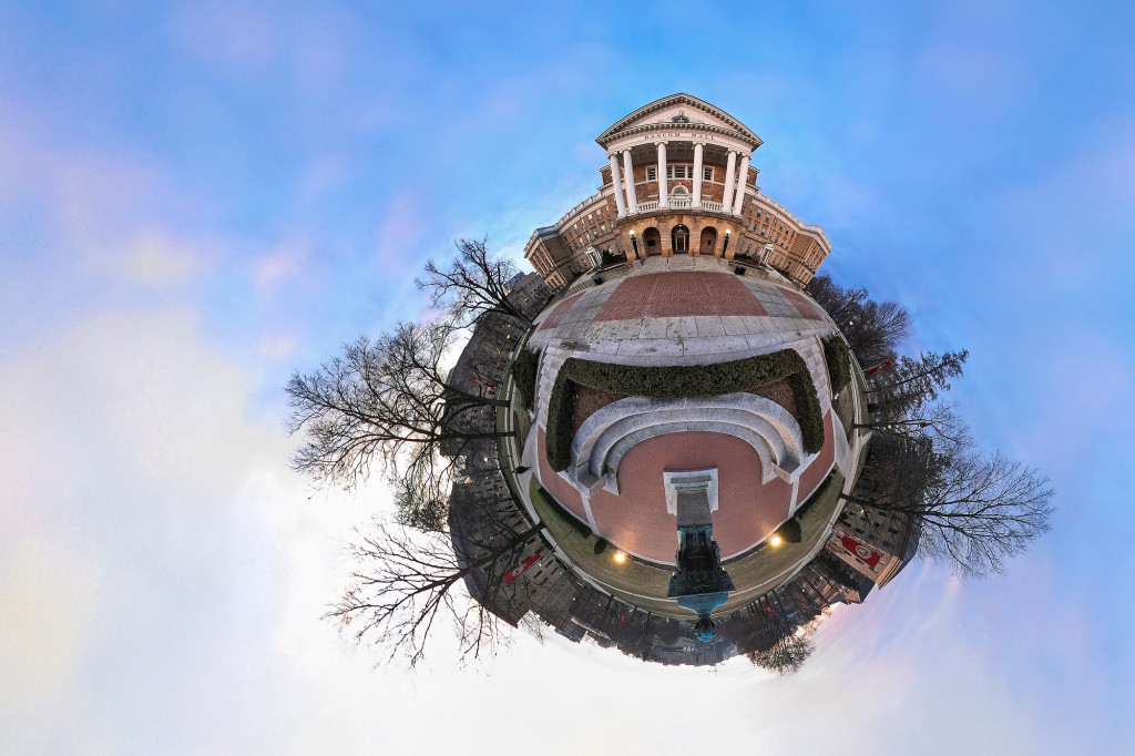 In a photo taken with a 360-degree lens, Bascom hall and surrounding buildings on bascom hill appear to sit around the perimeter of a small, orb-like planet that floats in the middle of a clear blue sky.