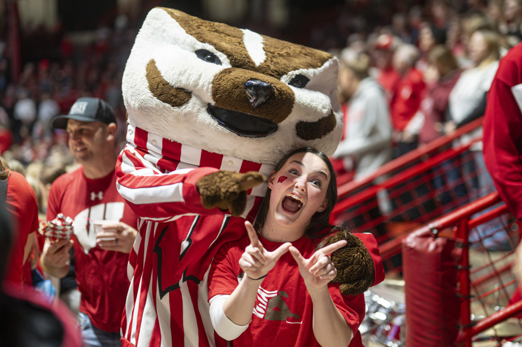 Bucky Badger and a fan give the W symbol.