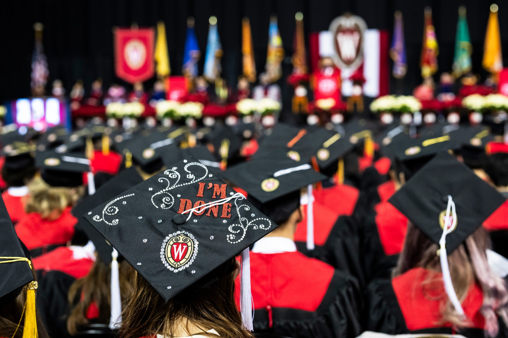 A commencement cap in a sea of others has the phrase "I'm done" and a UW logo on it.