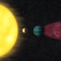 In an illustration of the sun and planets in a solar system, young, hot, Earth-sized planet HD 63433d sits close to its star. One side of the planet is brightly illuminated while the other side sits in darkness. To the right in the illustration, two neighboring, mini-Neptune-sized planets — one blue and one red — orbit farther out.