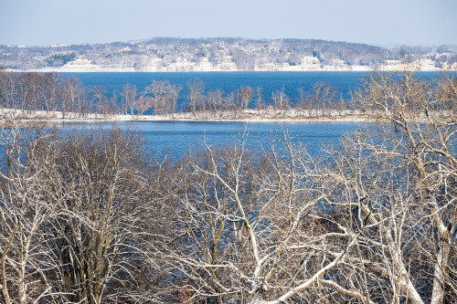 A lake with no ice is shown, although snow is on the shoreline.