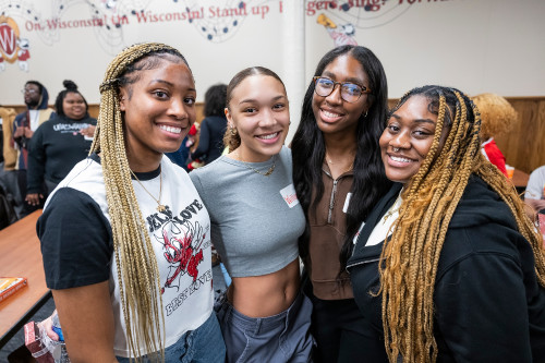 Four students pose together for a photo during a Black History Mont event.