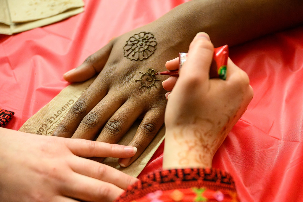 One hand draws patterns on another hand.