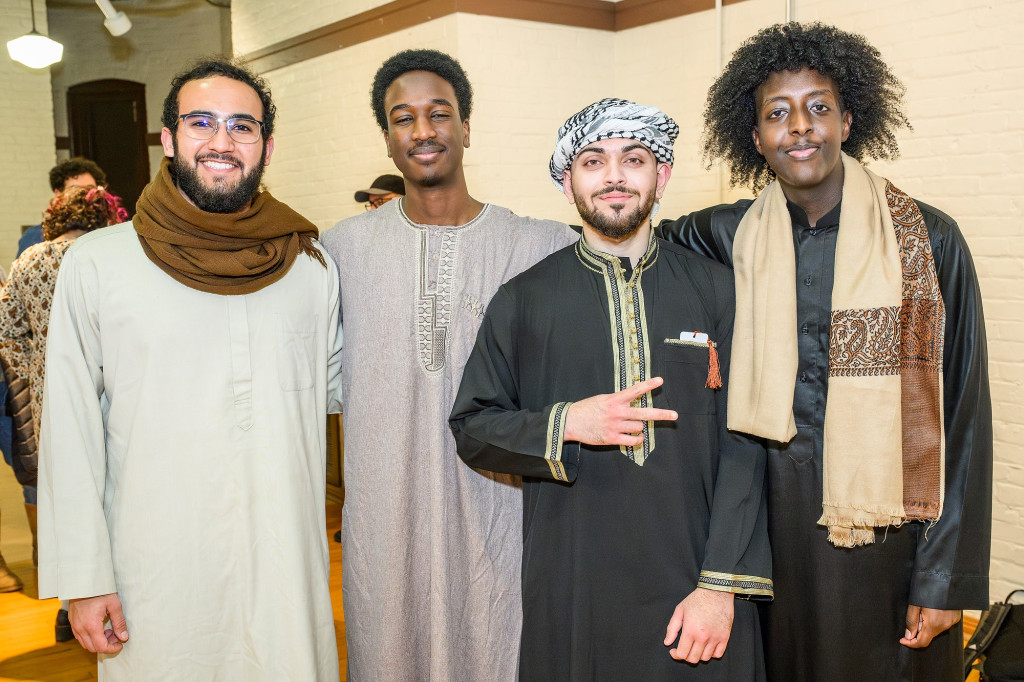 A group of people stand and pose for the camera.