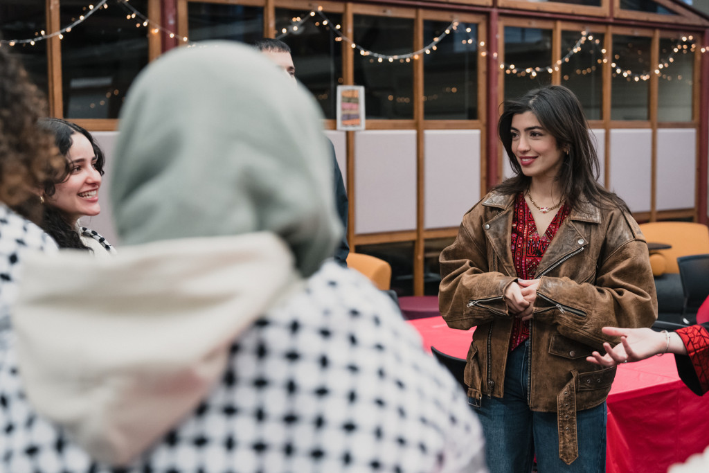 A woman listens to three people who are gathered around her.