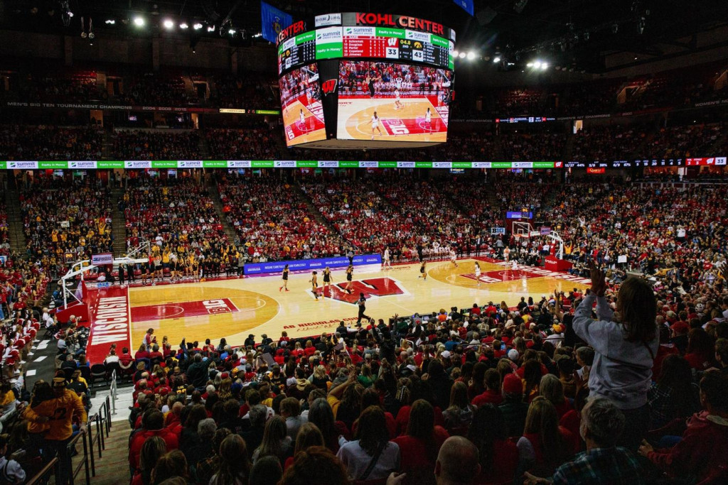 A wide shot of a basketball arena with the stands full of fans.